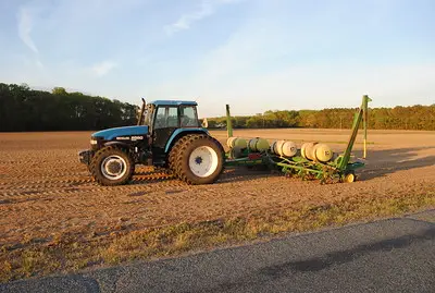 Ford tractor with a John Deere seeder / planter attachment.