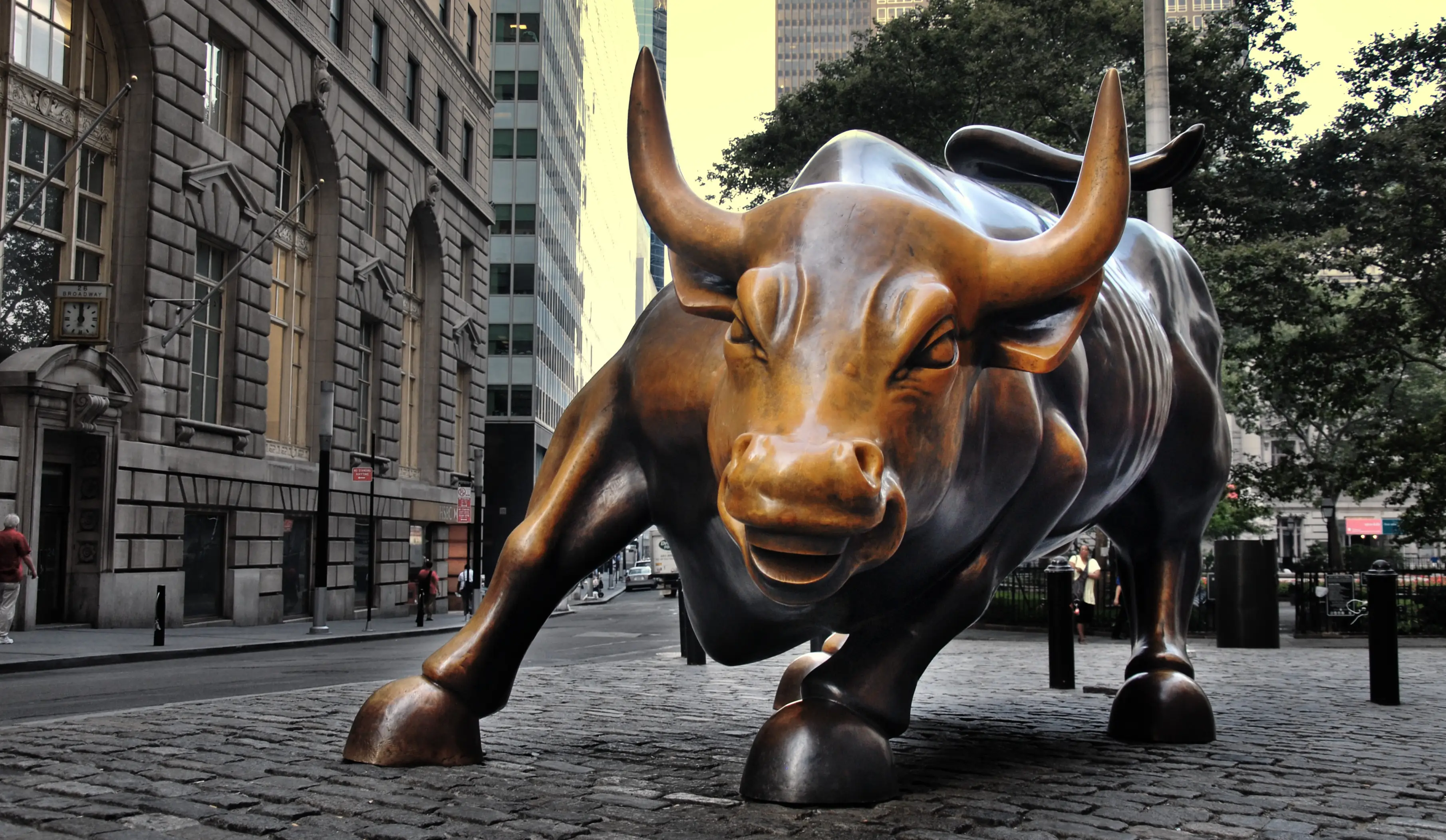 Bronze statue of a charging bull on Wall Street in New York City.