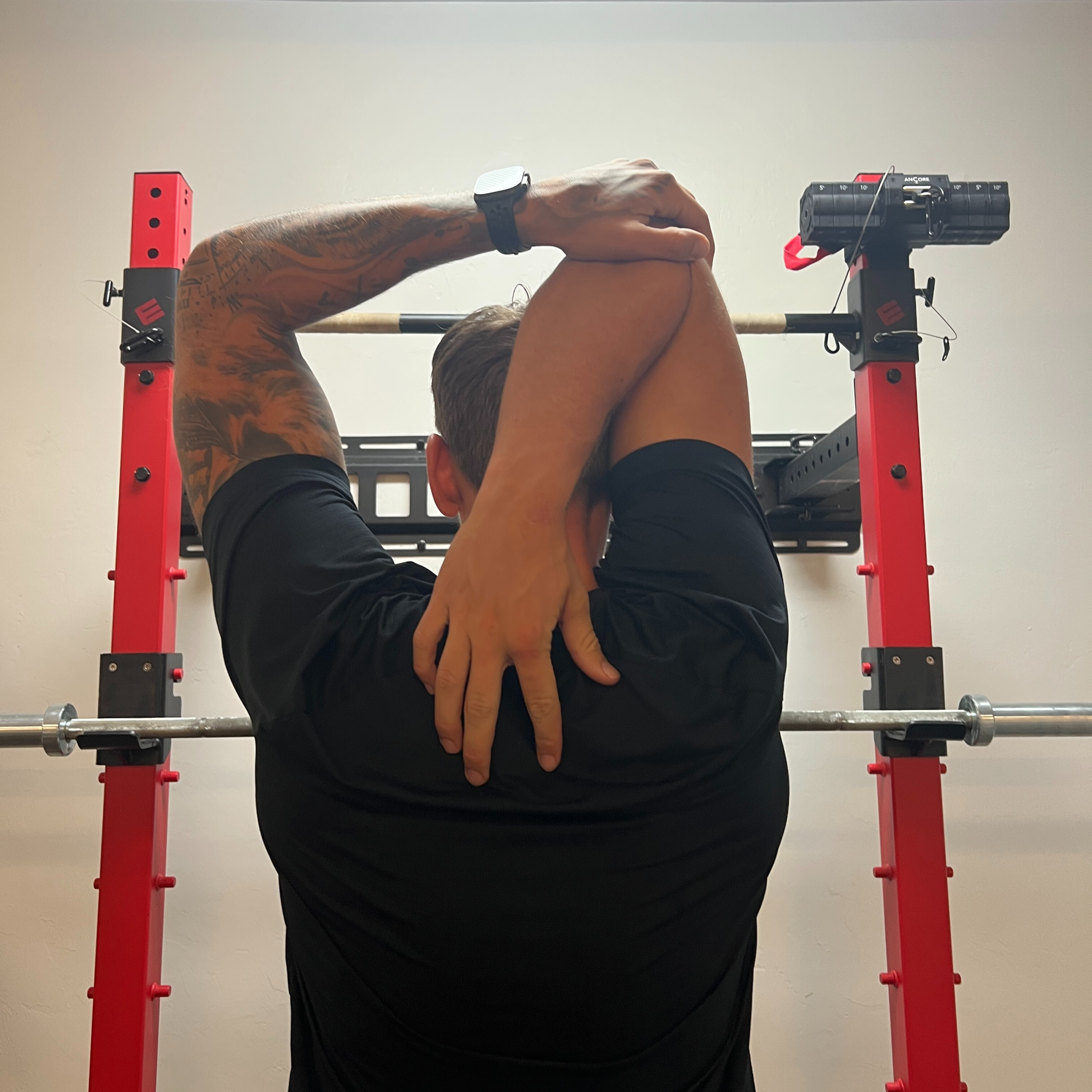 Behind-neck stretch (chicken wing)