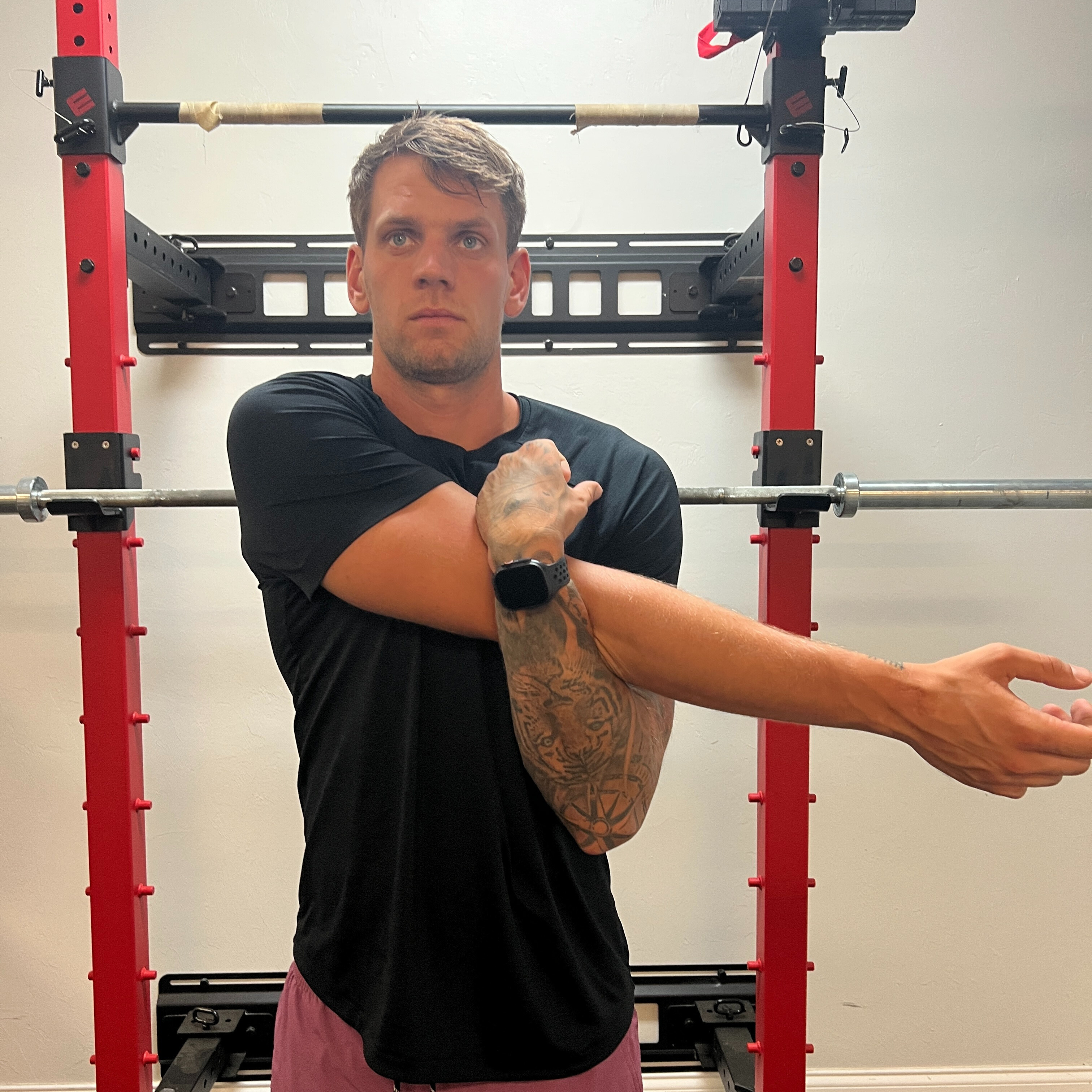 Cross arm in front of chest