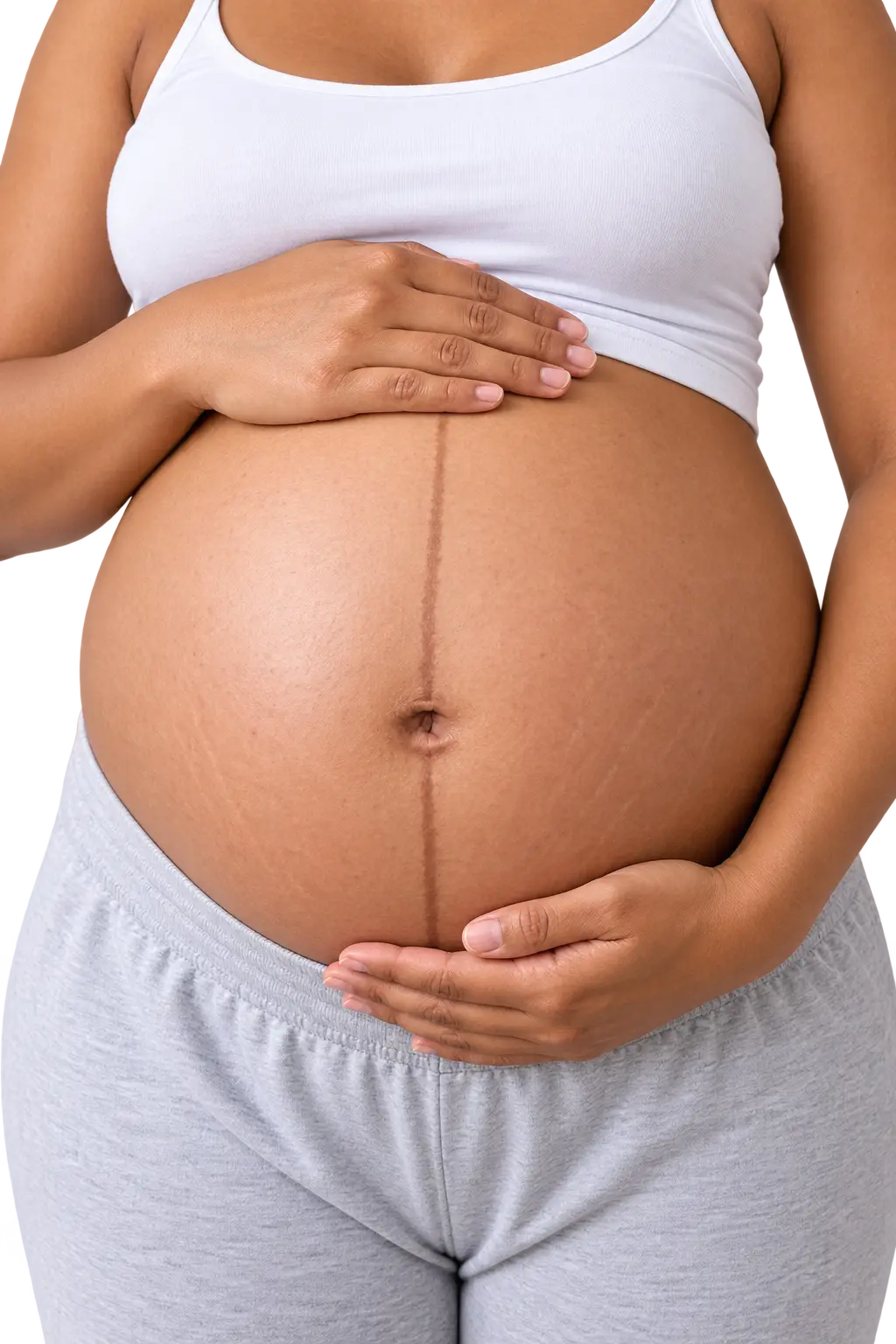 Close-up of a pregnant belly showing a dark vertical line, the linea nigra, running from above the navel down to the waistband of the pants.