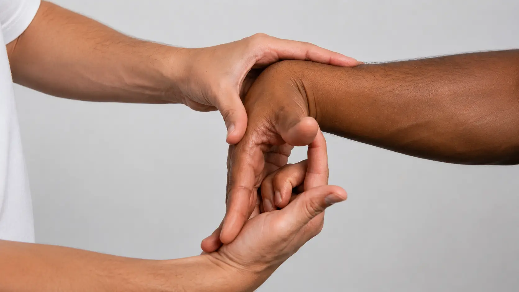 Therapist performs a thumb mobility assessment in two hand positions.